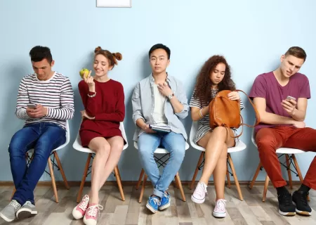 Grupo de jóvenes esperando para hacer una entrevista de trabajo.