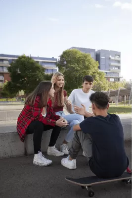 Quatre adolescents parlant en un parc